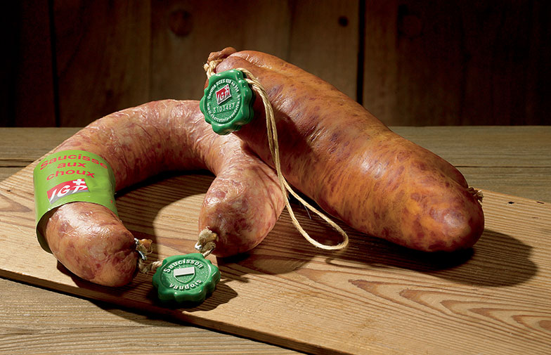 Le saucisson vaudois IGP et la saucisse aux choux IGP sont les seuls à pouvoir arborer le «plomb» vert des charcuteries vaudoises. | Photo: Association Patrimoine culinaire suisse